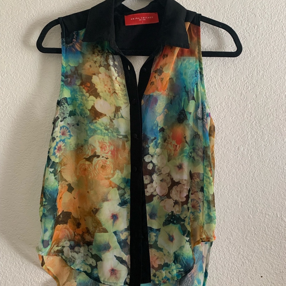 colorful sheer floral top with a black collar and a triangle cut-out in the back
